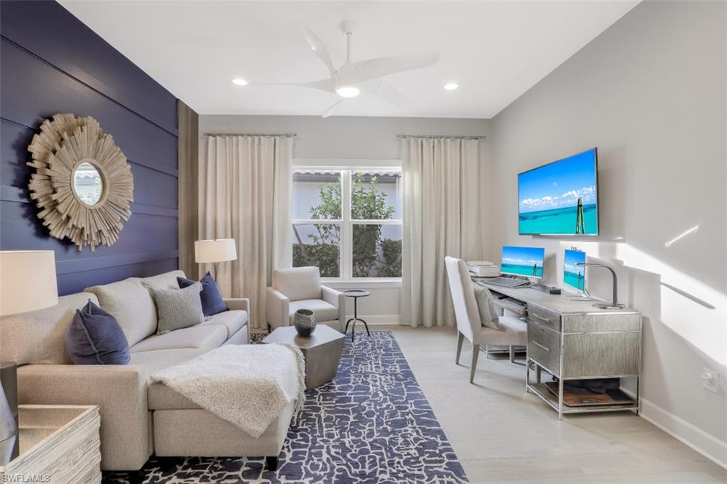 3258 Belon Lane Naples, FL 34114 - Photo 27 of 35 a living room with furniture a rug and a window