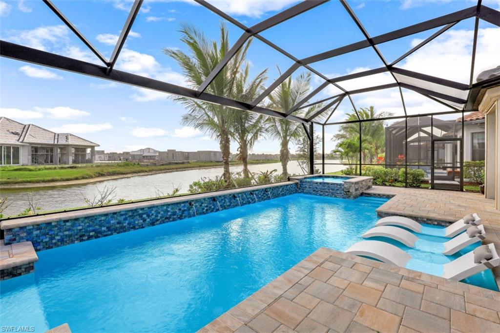 3258 Belon Lane Naples, FL 34114 - Photo 30 of 35 a view of swimming pool with outdoor seating and a yard
