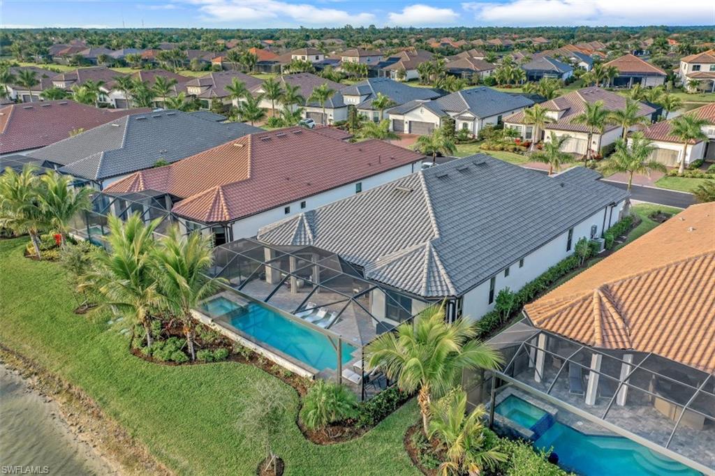 3258 Belon Lane Naples, FL 34114 - Photo 31 of 35 an aerial view of residential houses with outdoor space and trees