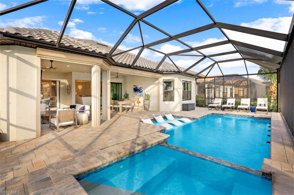 3258 Belon Lane Naples, FL 34114 - Photo 4 of 35 a view of a swimming pool with outdoor seating