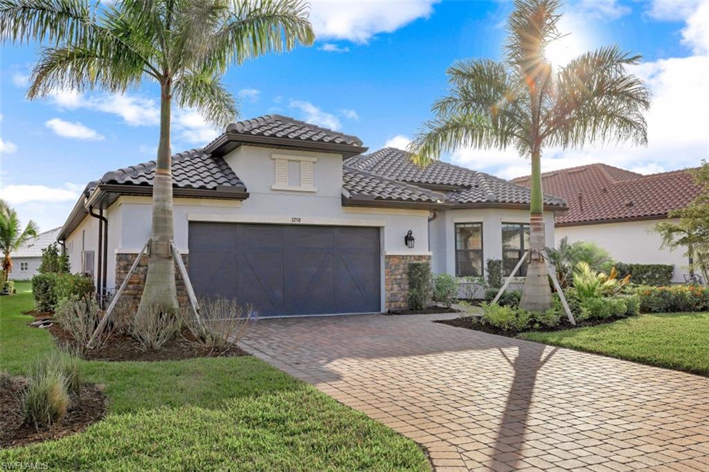 3258 Belon Lane Naples, FL 34114 - Photo 8 of 35 a front view of a house with a garden and palm tree