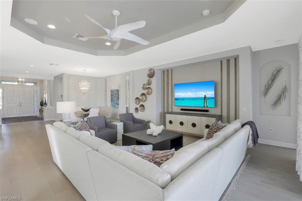 3258 Belon Lane Naples, FL 34114 - Photo 9 of 35 a living room with furniture and a flat screen tv