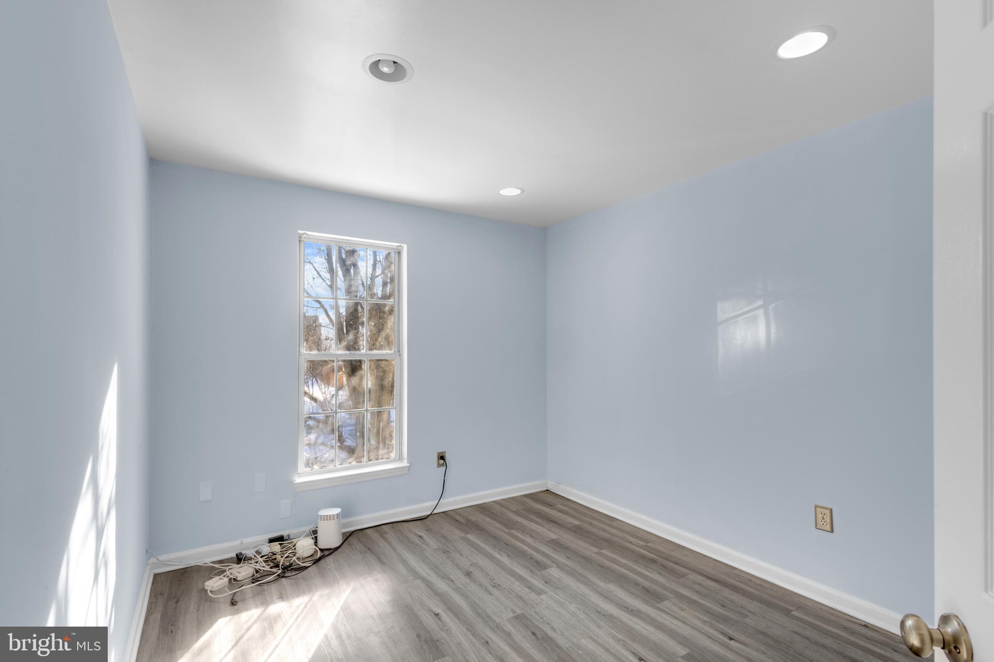 7510 Maury Road Baltimore, MD 21244 - Photo 21 of 39 an empty room with wooden floor and windows