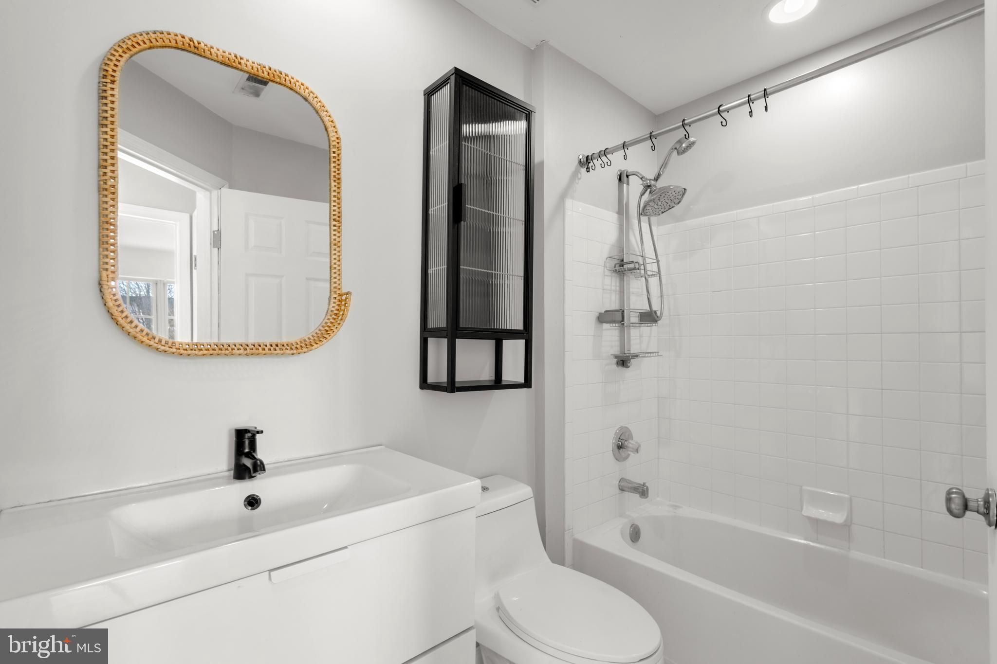 7510 Maury Road Baltimore, MD 21244 - Photo 26 of 39 a bathroom with a toilet a sink and a mirror
