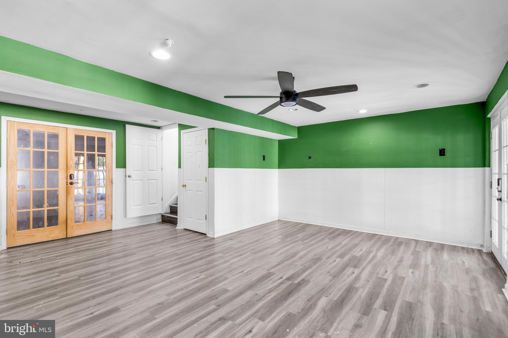 7510 Maury Road Baltimore, MD 21244 - Photo 28 of 39 a view of an empty room with wooden floor and a ceiling fan