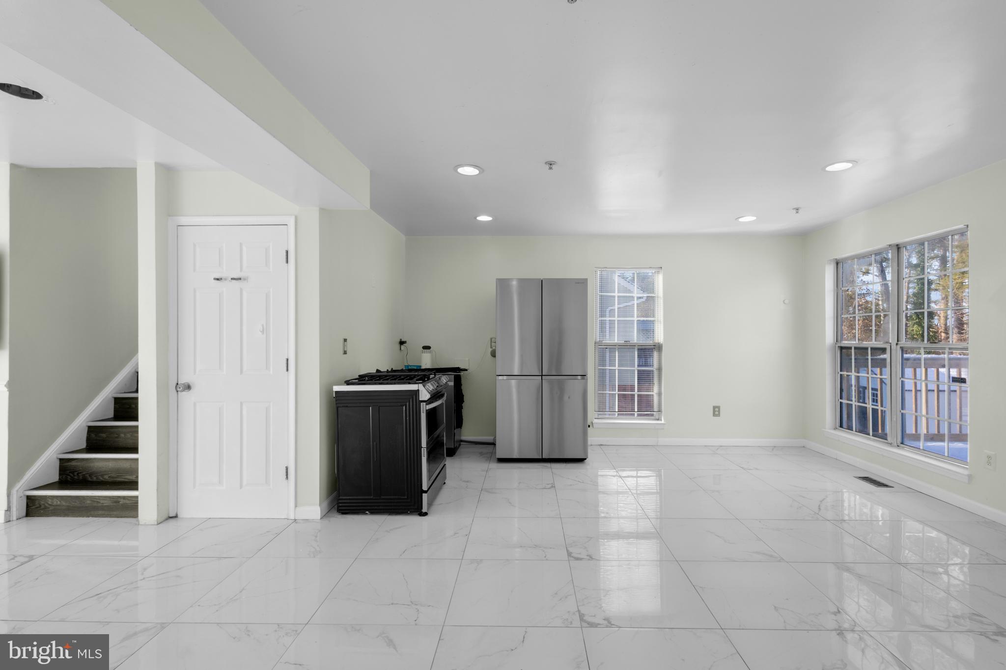 7510 Maury Road Baltimore, MD 21244 - Photo 7 of 39 a view of a big room with kitchen and windows