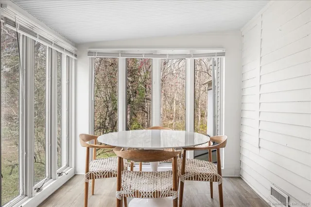 a view of a room with a table and chairs