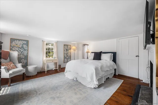 a bed room with furniture and a flat screen tv