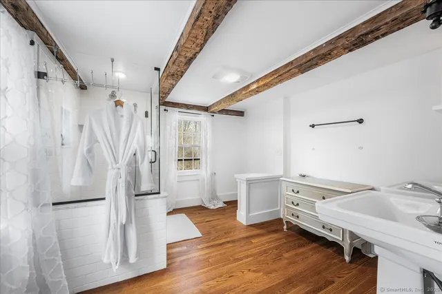 a spacious bathroom with a sink mirror and toilet