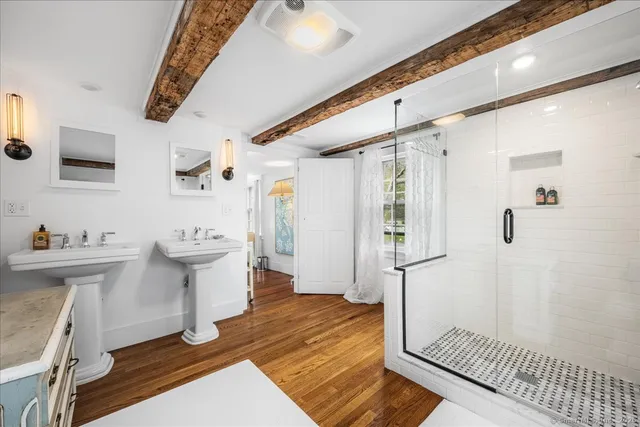 a room with a bed and wooden floor