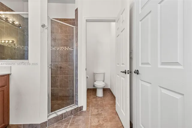 a bathroom with a shower and a toilet