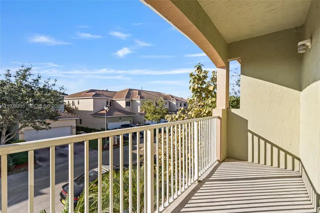 a view of a balcony with wooden floor