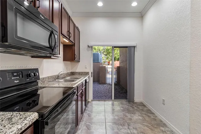 a kitchen with stainless steel appliances granite countertop a stove and a microwave