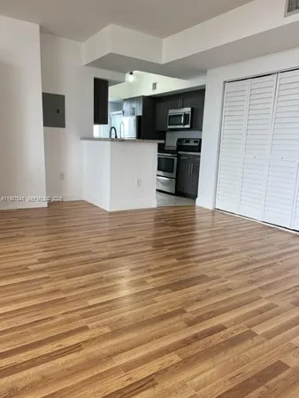 a view of a kitchen with a sink and a microwave