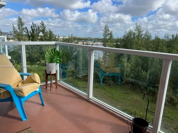 a view of a chair and table in the balcony