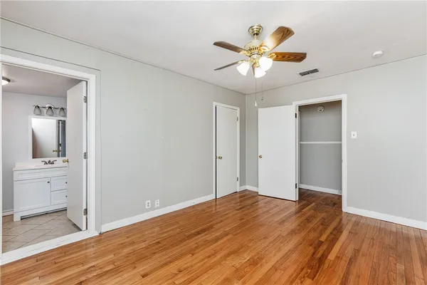a bathroom with a shower sink vanity mirror and toilet