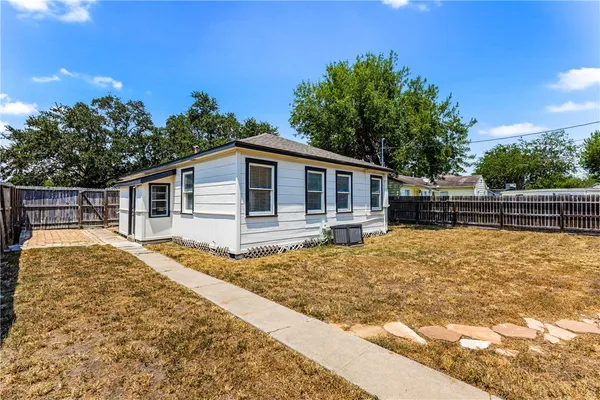 a backyard of a house with yard and outdoor seating