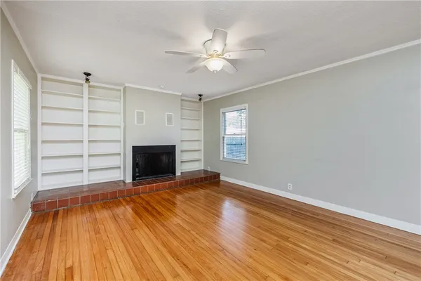 wooden floor in an empty room with a fireplace
