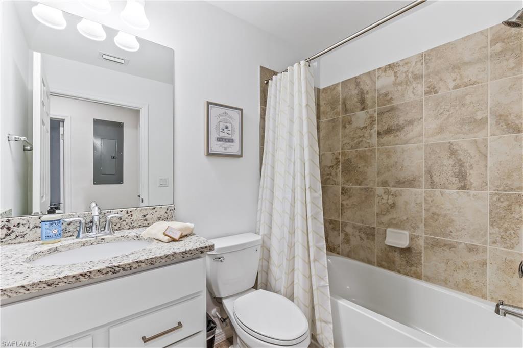 Undisclosed Address Punta Gorda, FL 33982 - Photo 13 of 14 a bathroom with a granite countertop sink a toilet a mirror a bathtub and shower