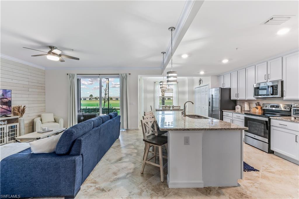 Undisclosed Address Punta Gorda, FL 33982 - Photo 5 of 14 a living room with stainless steel appliances granite countertop furniture a kitchen island a sink a stove and a window