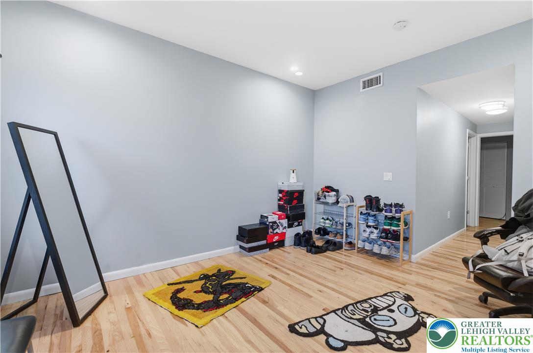 623 Walnut Street, Unit A2 Easton, PA 18042 - Photo 12 of 21 a bed room with furniture and a wooden floor