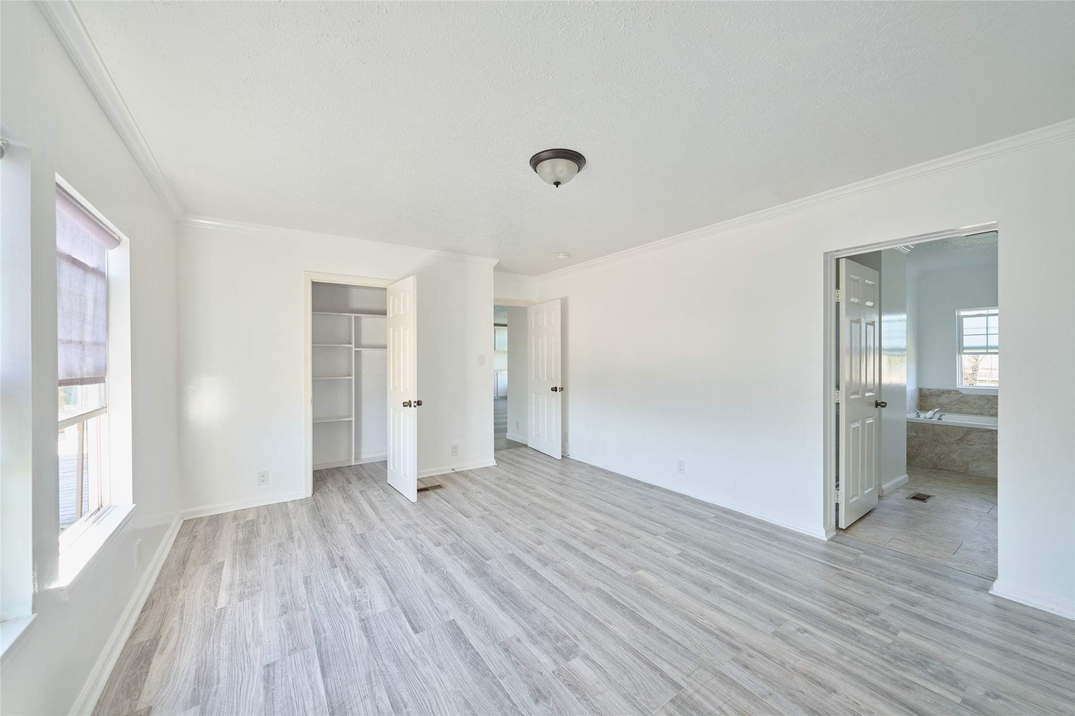 928 Coen Road Rosharon, TX 77583 - Photo 11 of 18 wooden floor in an empty room with a window