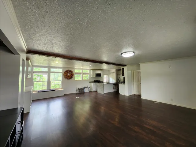 a view of kitchen and hall with wooden floor