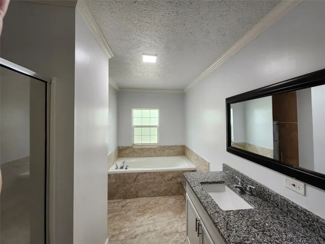 a view of an empty room and wooden floor