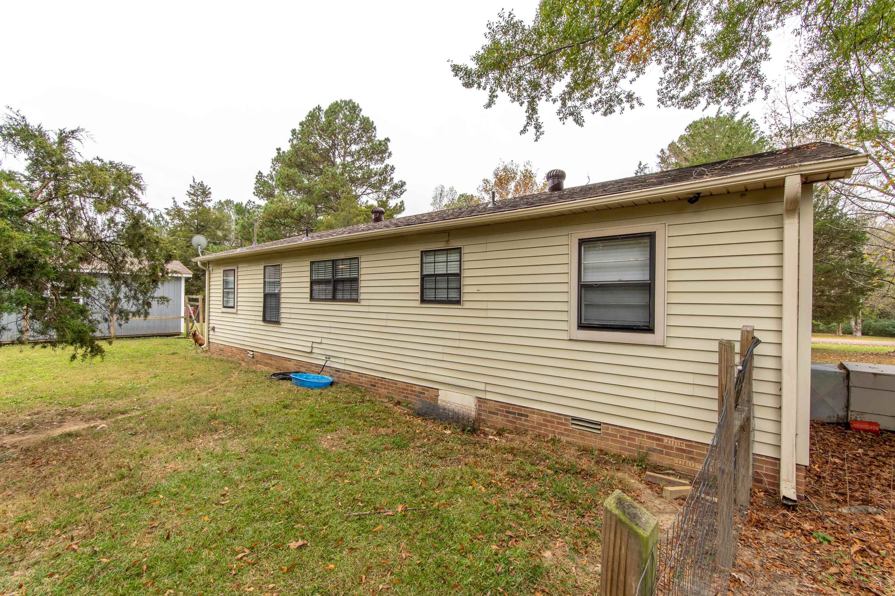 109 Pyron Street Adamsville, TN 38310 - Photo 30 of 36 a view of a house with a yard