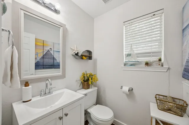 a bathroom with a toilet a sink and a mirror