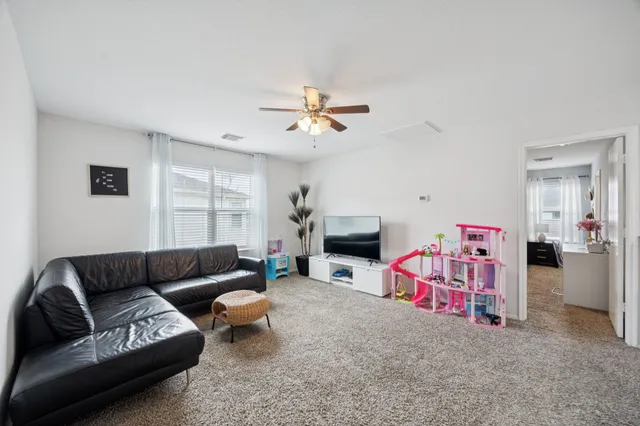 a living room with furniture a fireplace and a chandelier