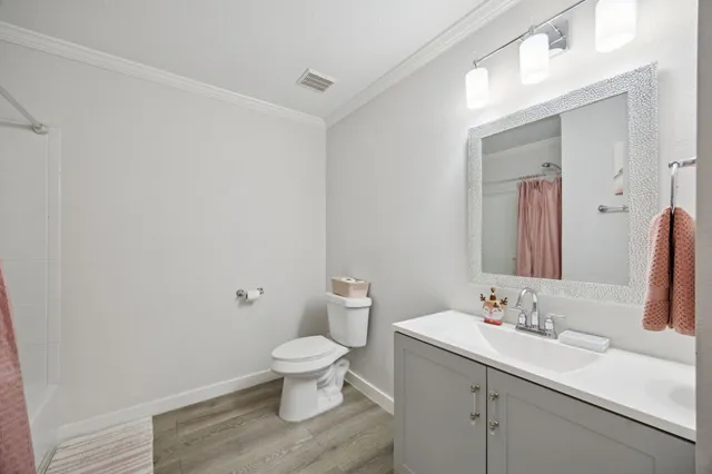 a bathroom with a sink toilet and a mirror