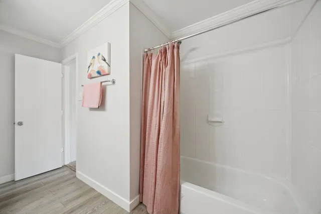 a bathroom with a shower and a curtain
