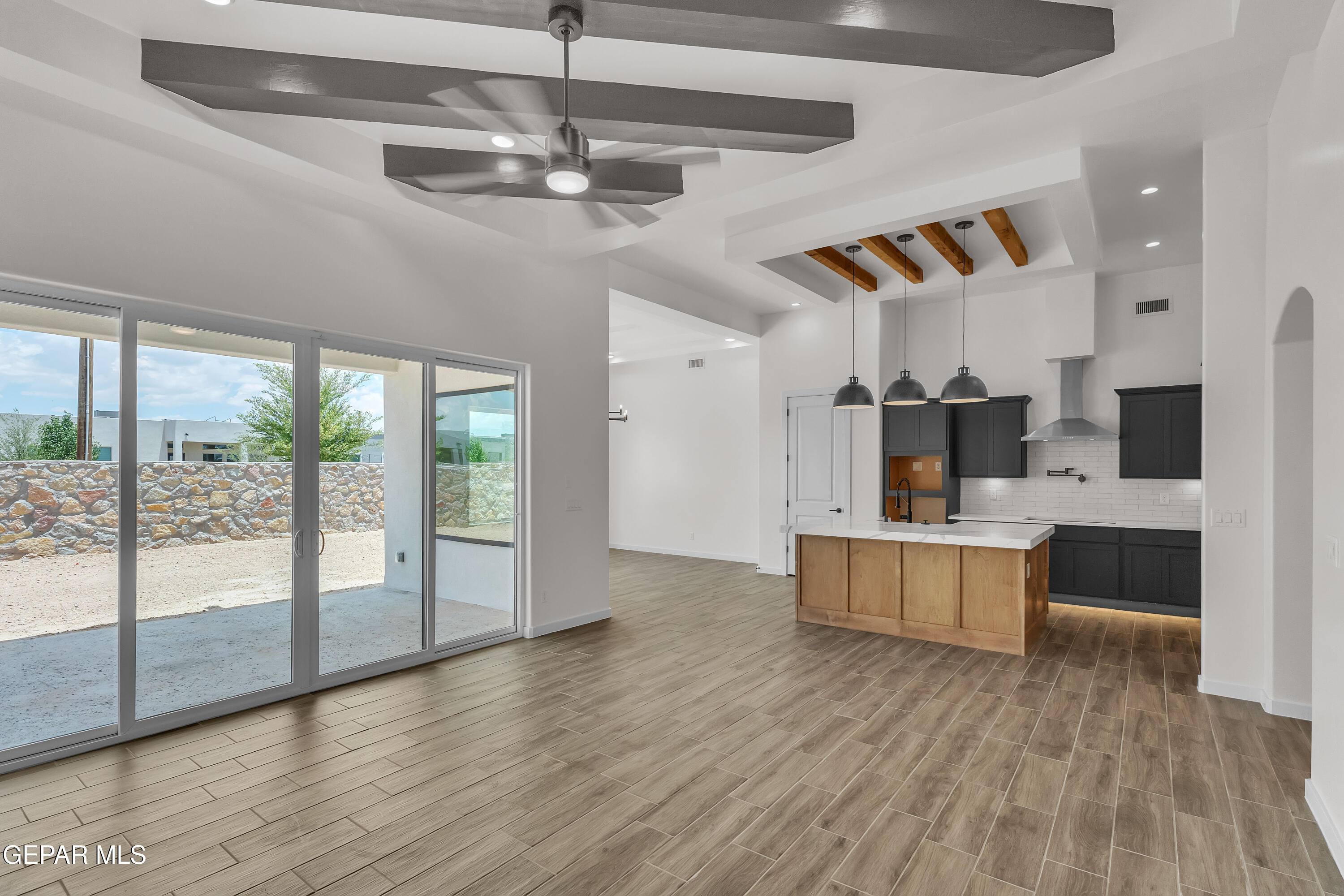 7264 Cimarron Rim Drive El Paso, TX 79911 - Photo 5 of 21 a kitchen with stainless steel appliances kitchen island wooden floors and large window