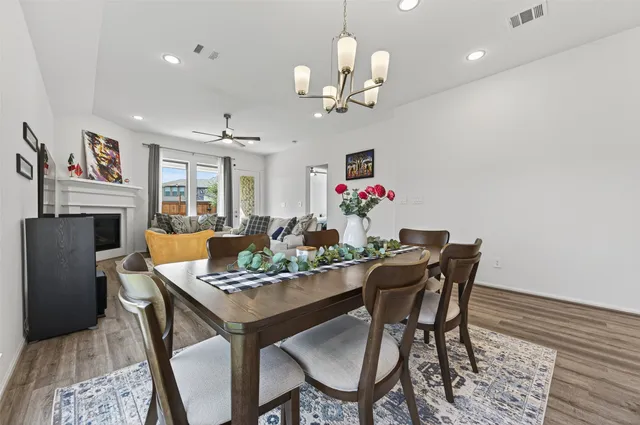 a living room with furniture a flat screen tv and a window