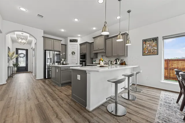a view of a dining room with furniture and chandelier