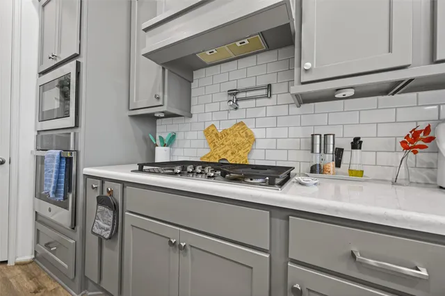 a living room with furniture a rug and a flat screen tv
