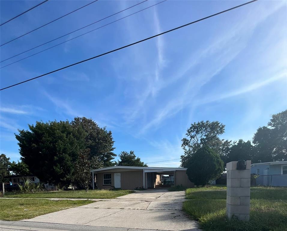7513 Robindale Road Tampa, FL 33619 - Photo 1 of 1 a front view of a house with a yard