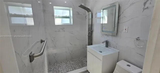 a bathroom with a sink toilet and shower