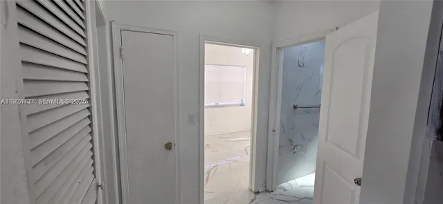 a bathroom with a glass shower door