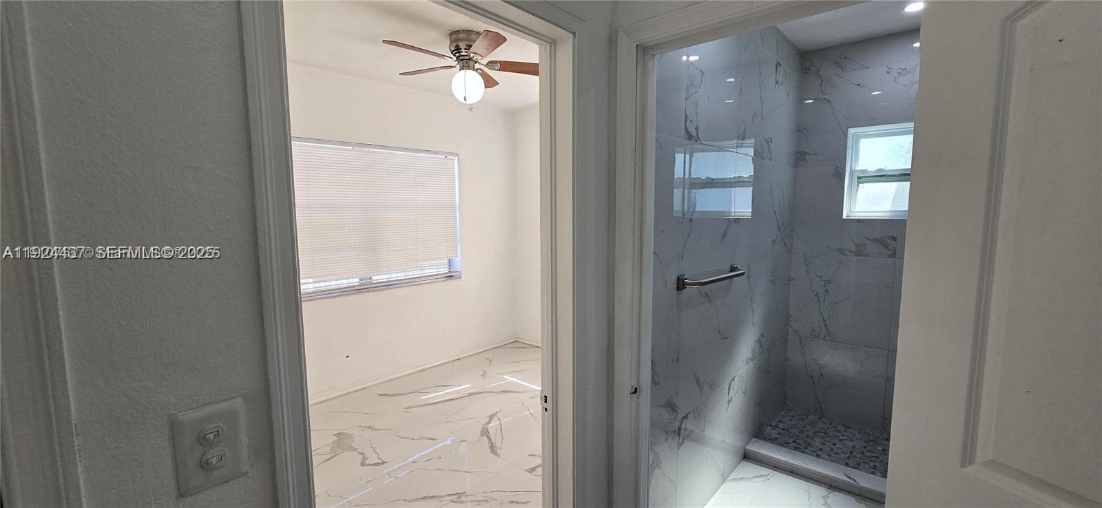 12140 Southwest 218th Street Miami, FL 33170 - Photo 8 of 11 a bathroom with a glass shower door