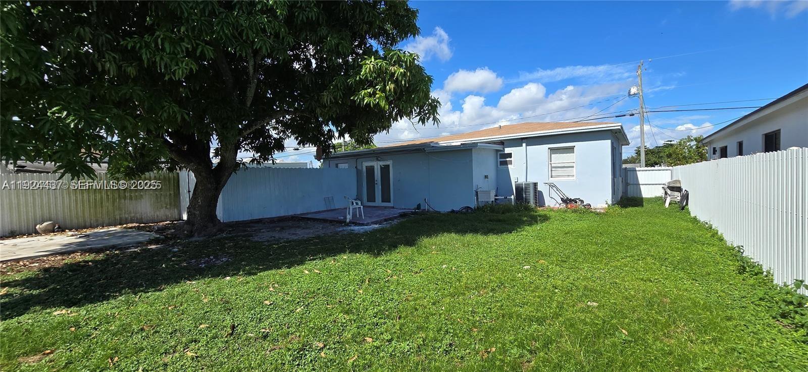 12140 Southwest 218th Street Miami, FL 33170 - Photo 9 of 11 a view of a house with a yard
