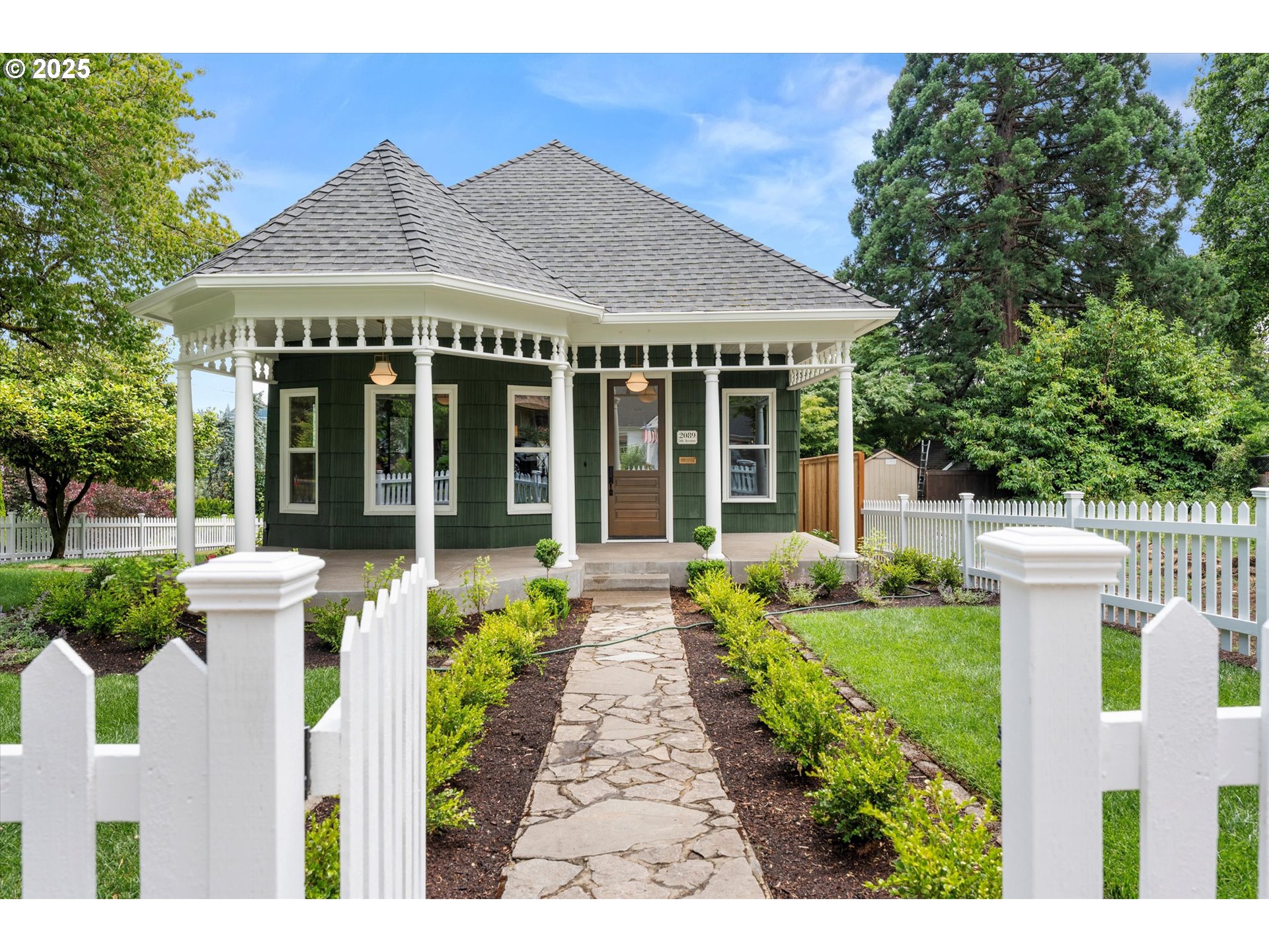 a front view of a house with a garden