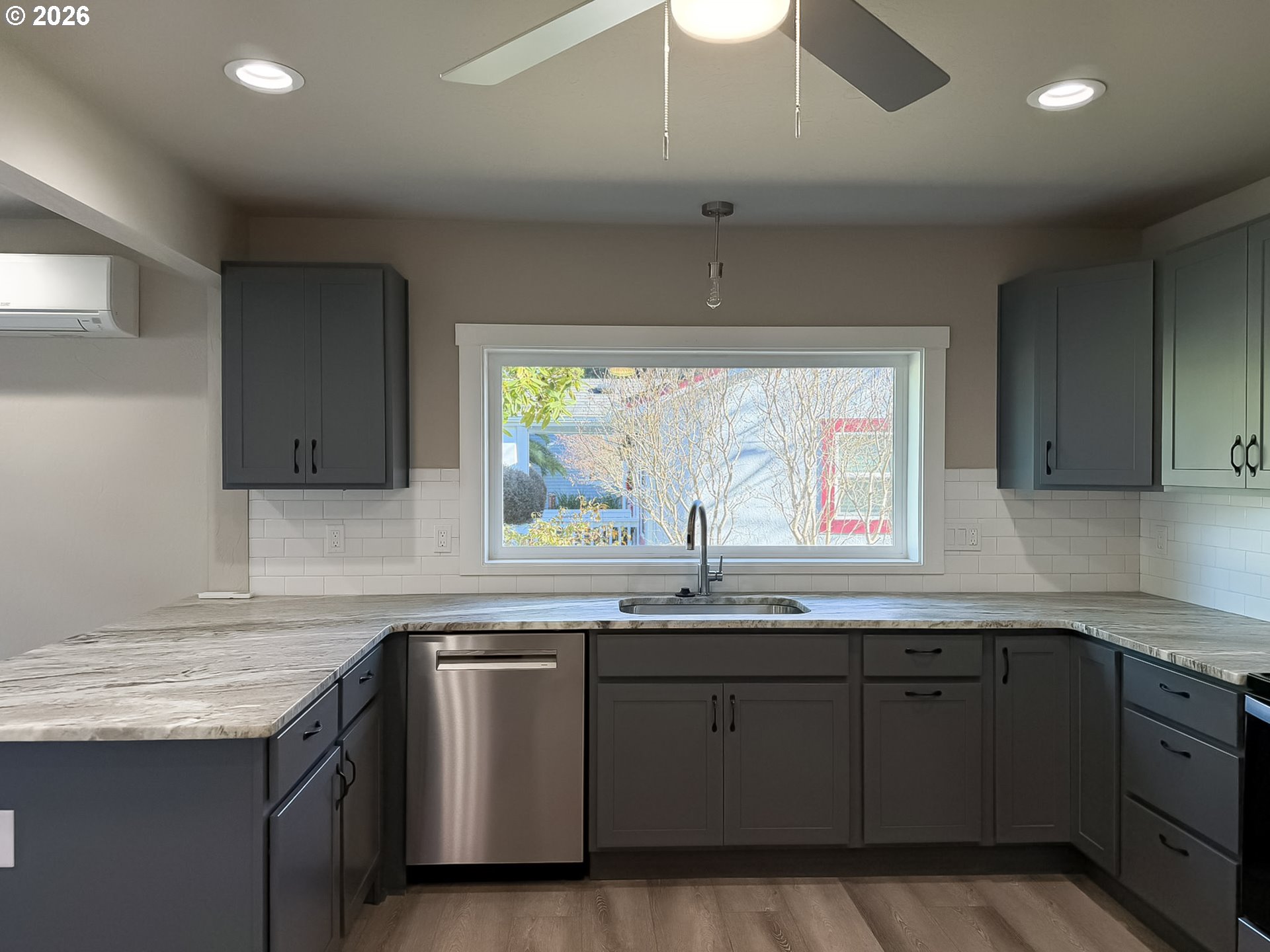 325 Railroad Street Brookings, OR 97415 - Photo 14 of 38 a kitchen with stainless steel appliances granite countertop a sink a stove and cabinets