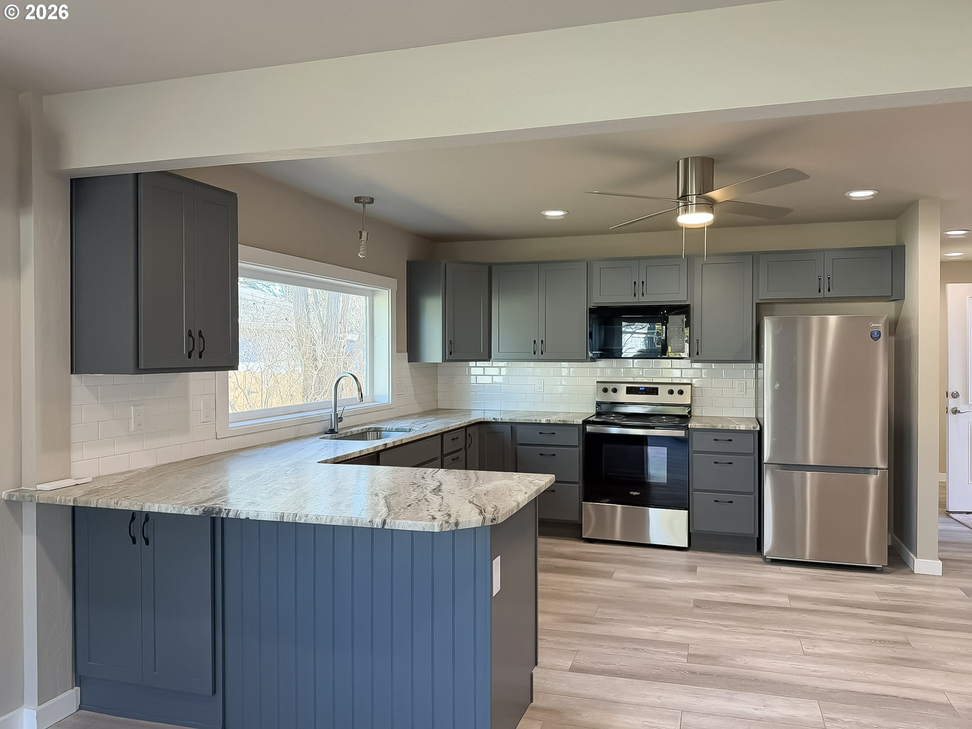 325 Railroad Street Brookings, OR 97415 - Photo 17 of 38 a large kitchen with granite countertop a large counter top stainless steel appliances and cabinets