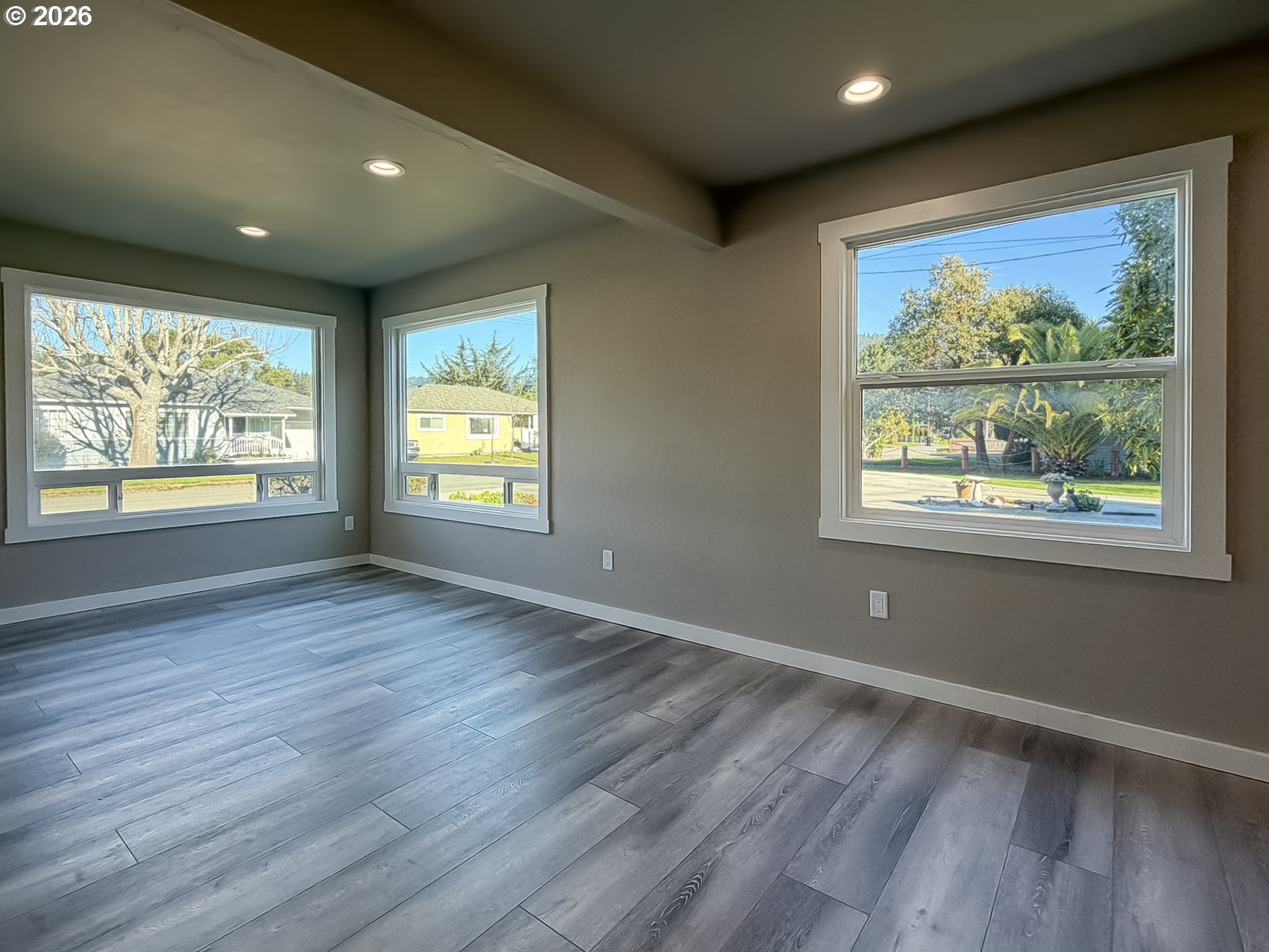 325 Railroad Street Brookings, OR 97415 - Photo 18 of 38 a view of an empty room with wooden floor and a window