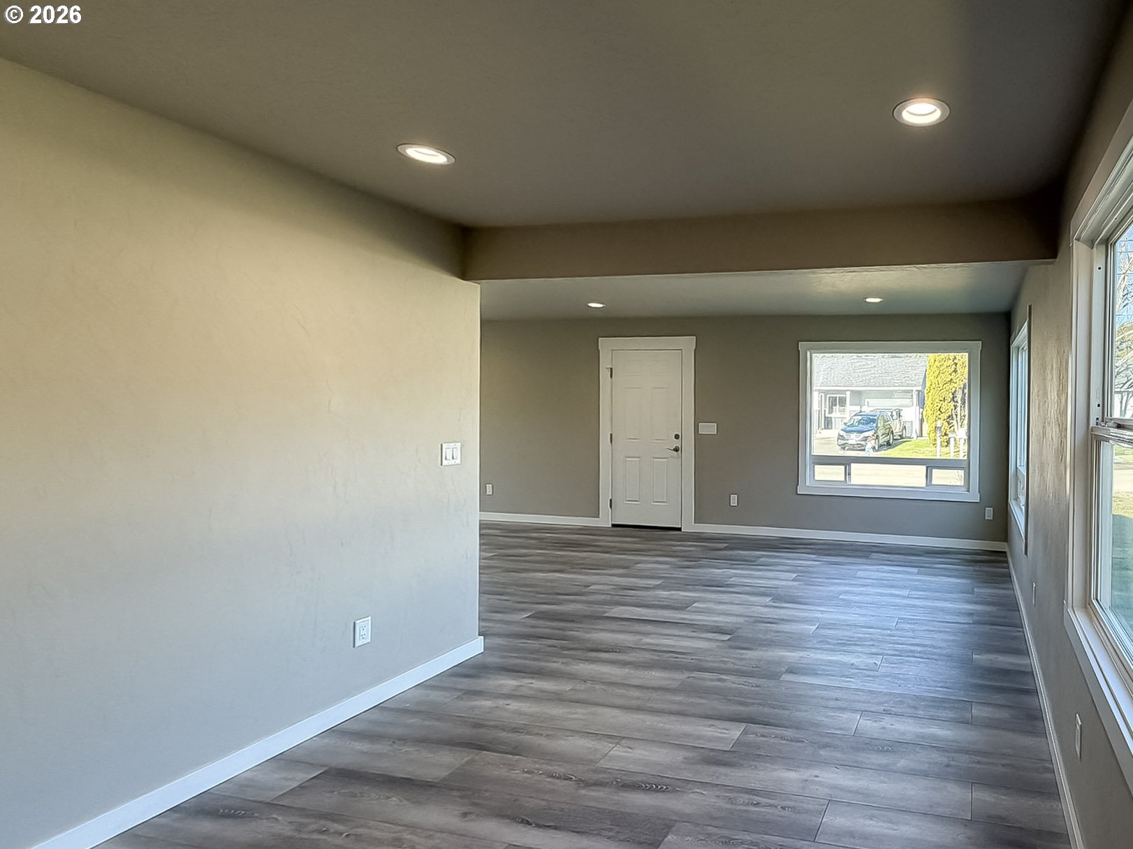 325 Railroad Street Brookings, OR 97415 - Photo 19 of 38 an empty room with wooden floor and windows