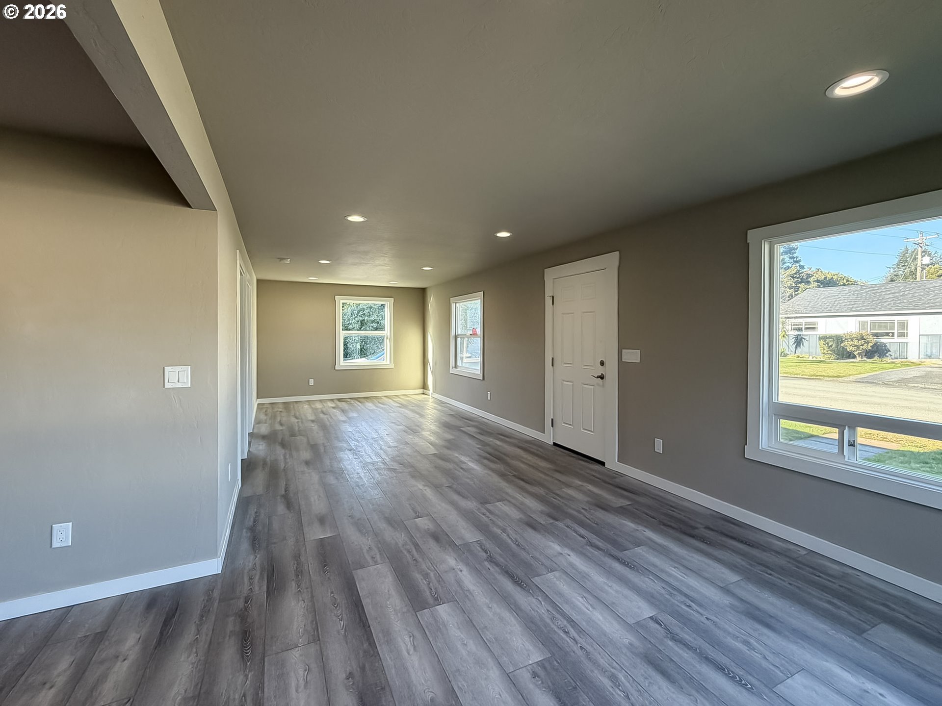 325 Railroad Street Brookings, OR 97415 - Photo 20 of 38 a view of an empty room with wooden floor and a window