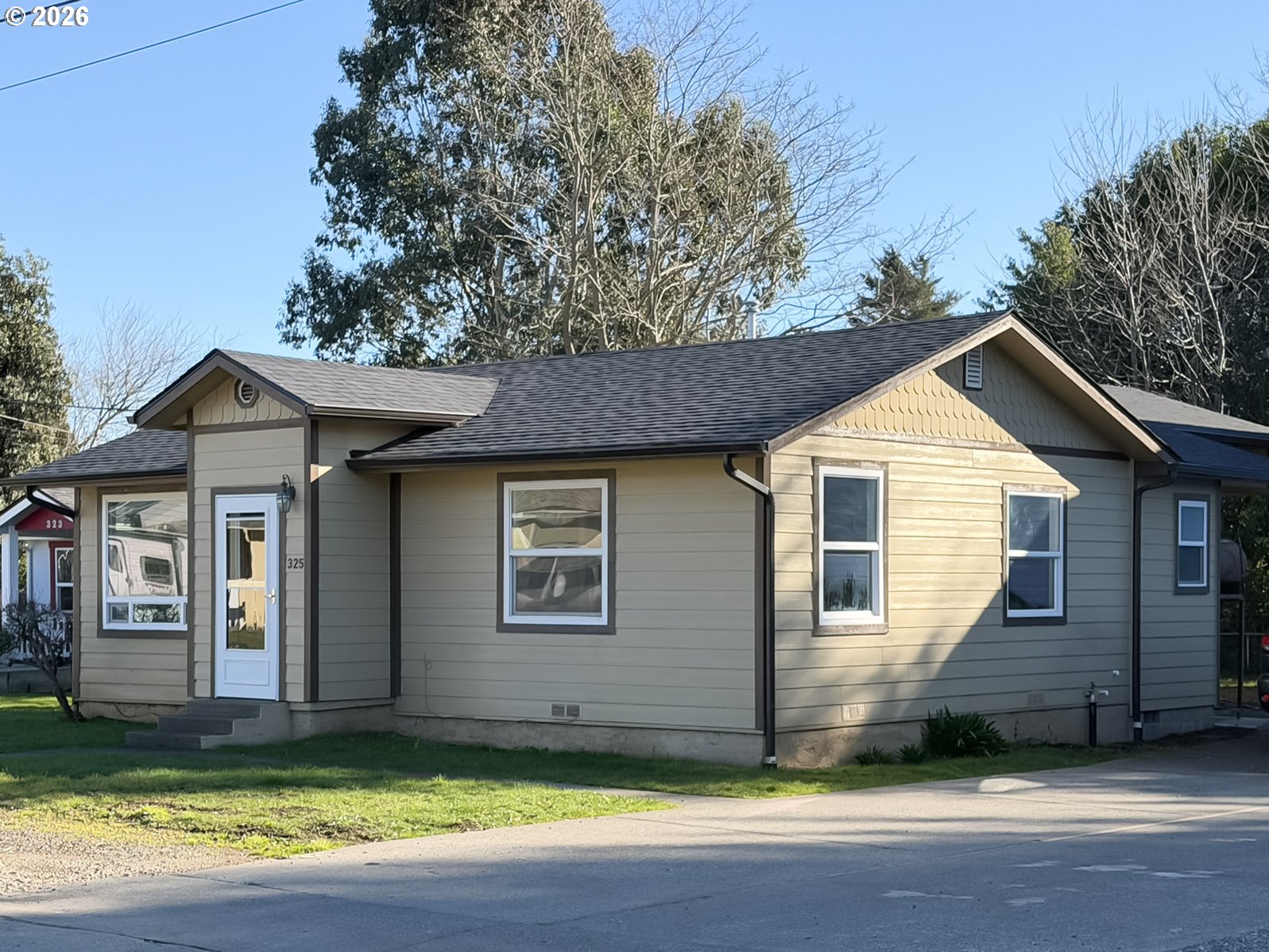 325 Railroad Street Brookings, OR 97415 - Photo 2 of 38 a view of a house with a yard and large tree