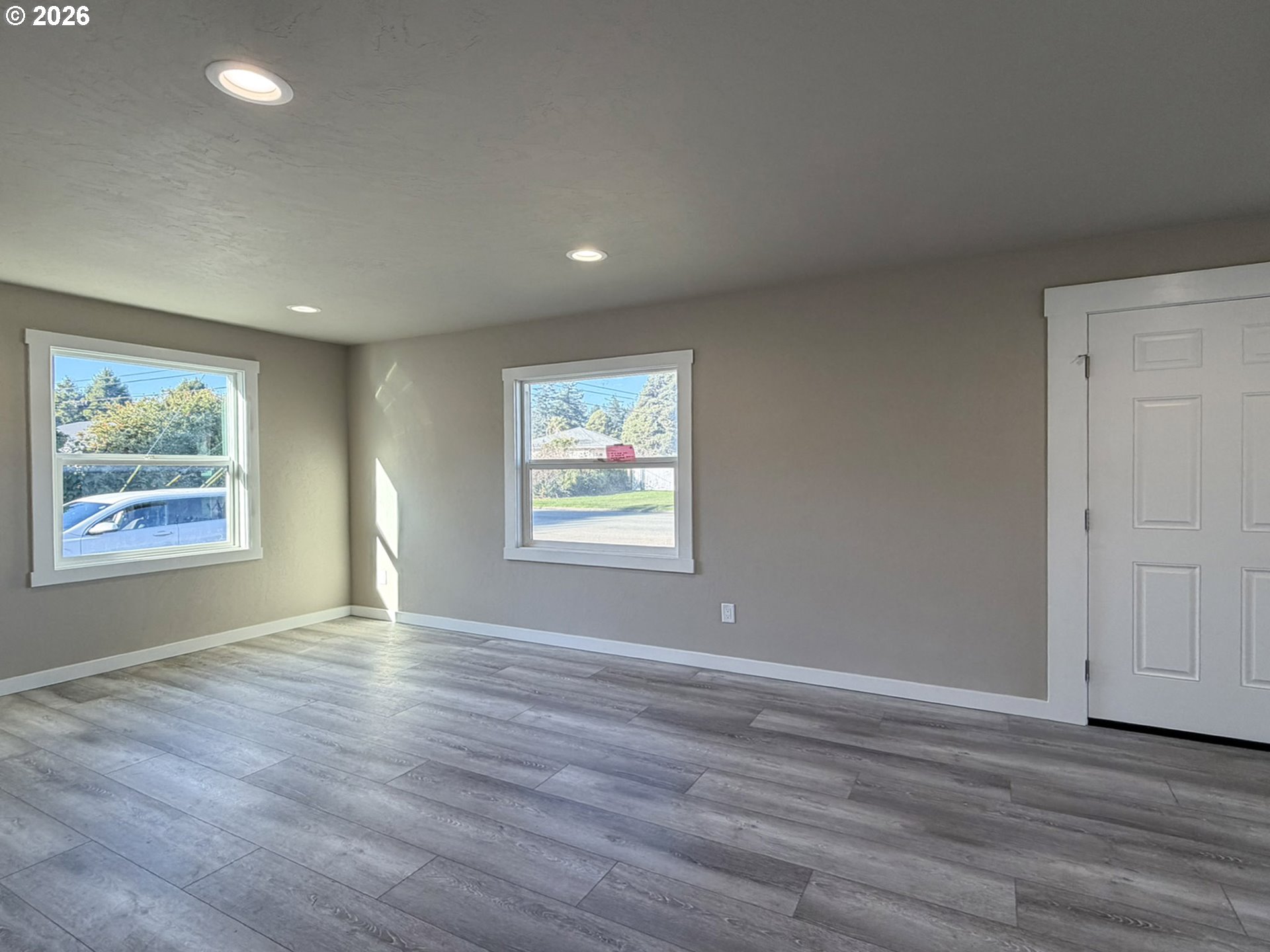 325 Railroad Street Brookings, OR 97415 - Photo 23 of 38 a view of an empty room with wooden floor and a window
